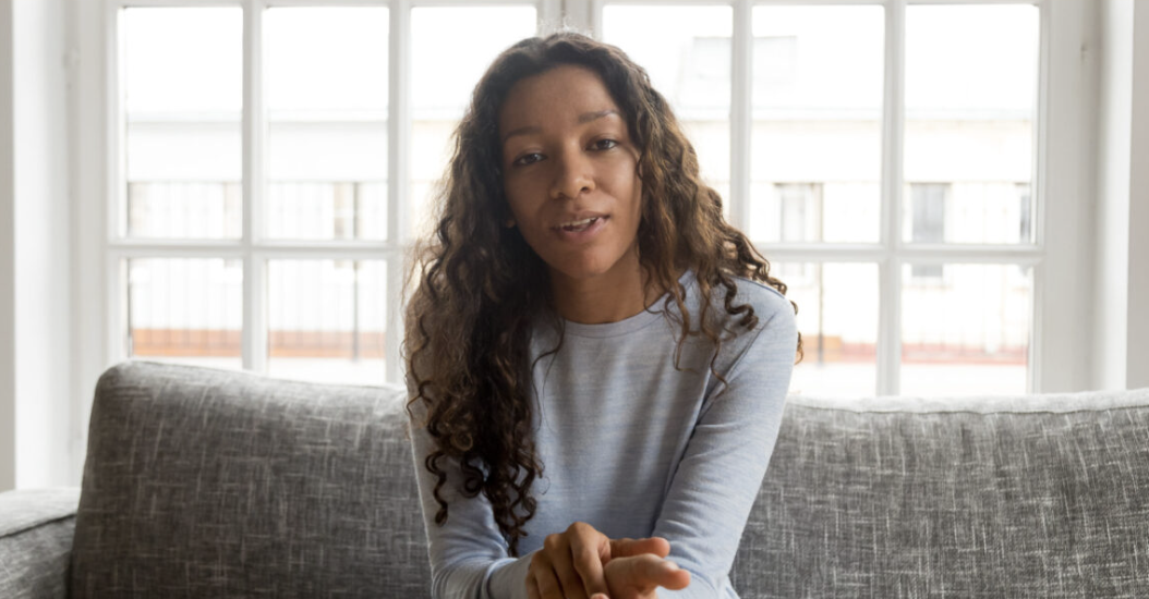 Stock photo of a person speaking on a video call (illustration, not a client)